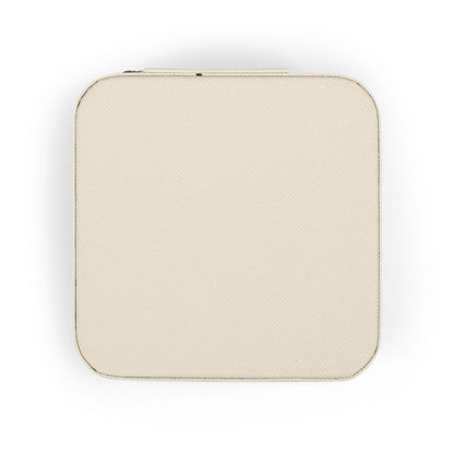 Cream colored jewelry box with textured surface and zipper closure.