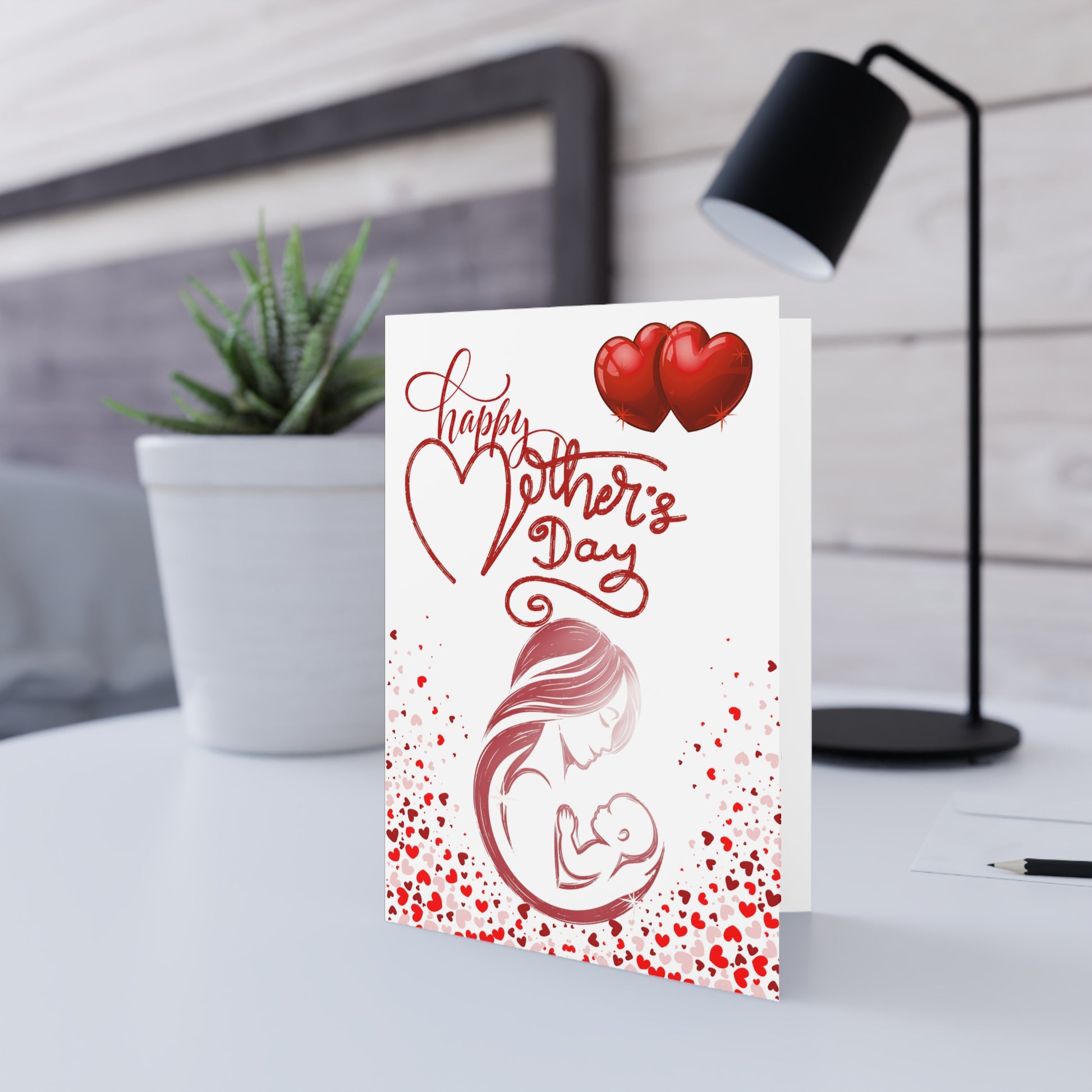 Card with "Happy Mother's Day" text, mother holding baby, and red hearts.