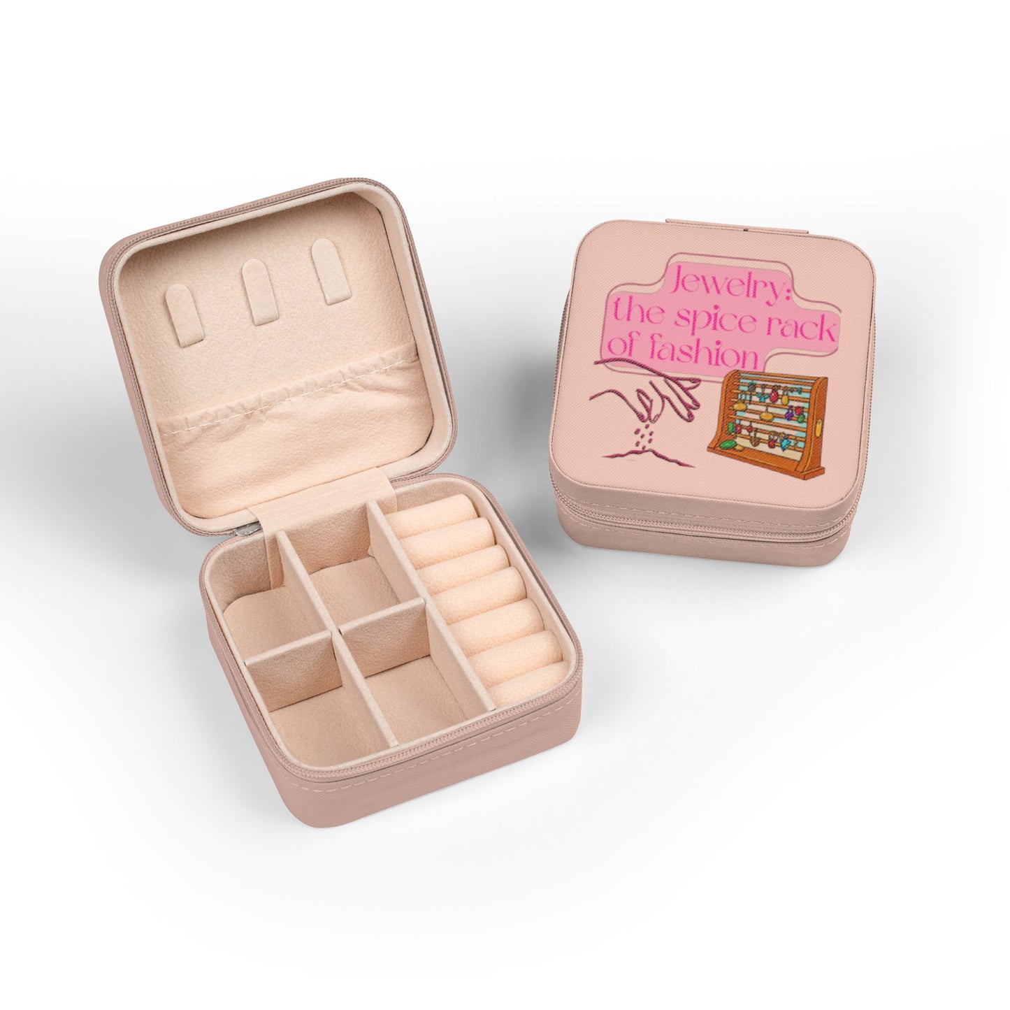 Pink jewelry box, open, showing compartments and a closed box with fashion graphic.