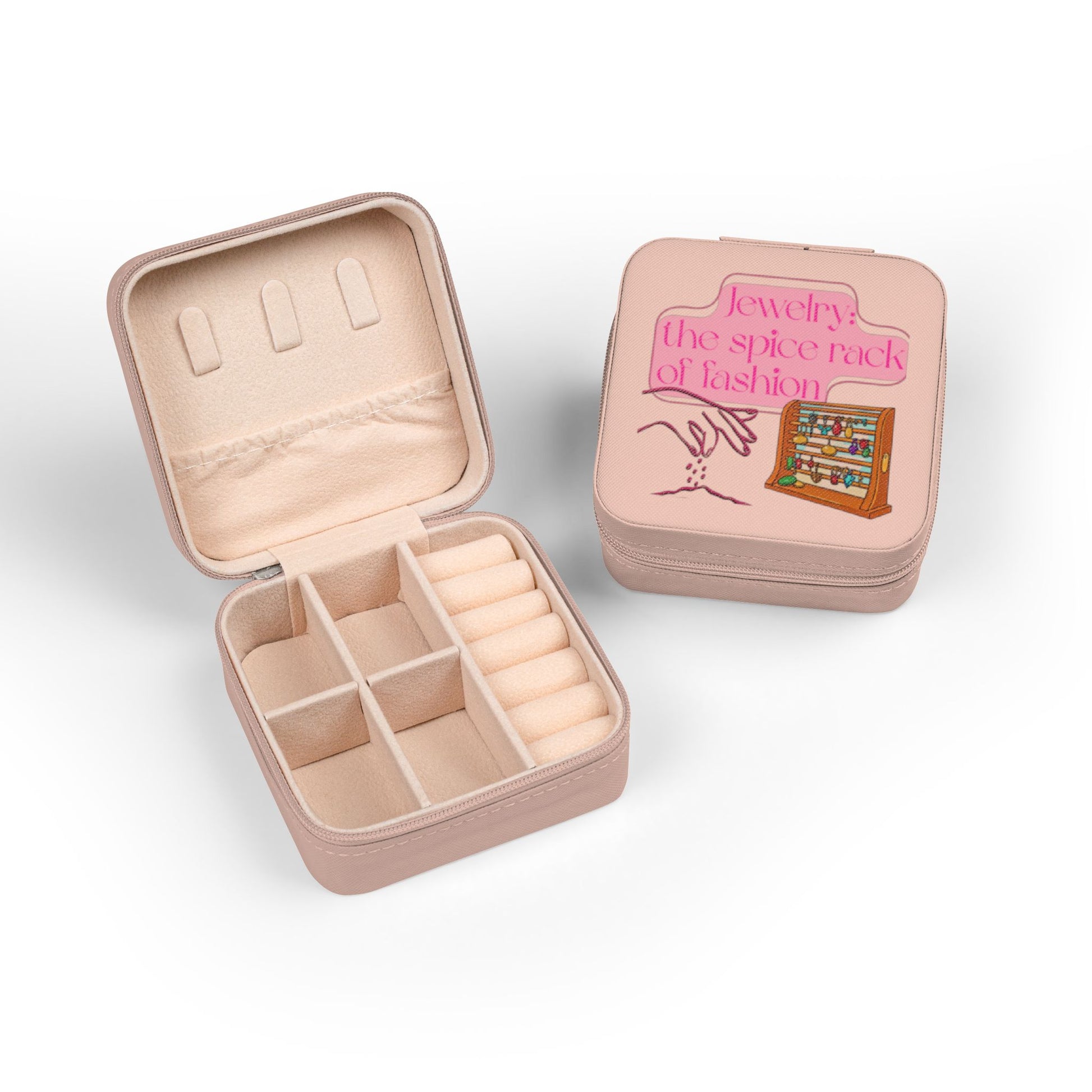 Pink jewelry box, open, showing compartments and a closed box with fashion graphic.